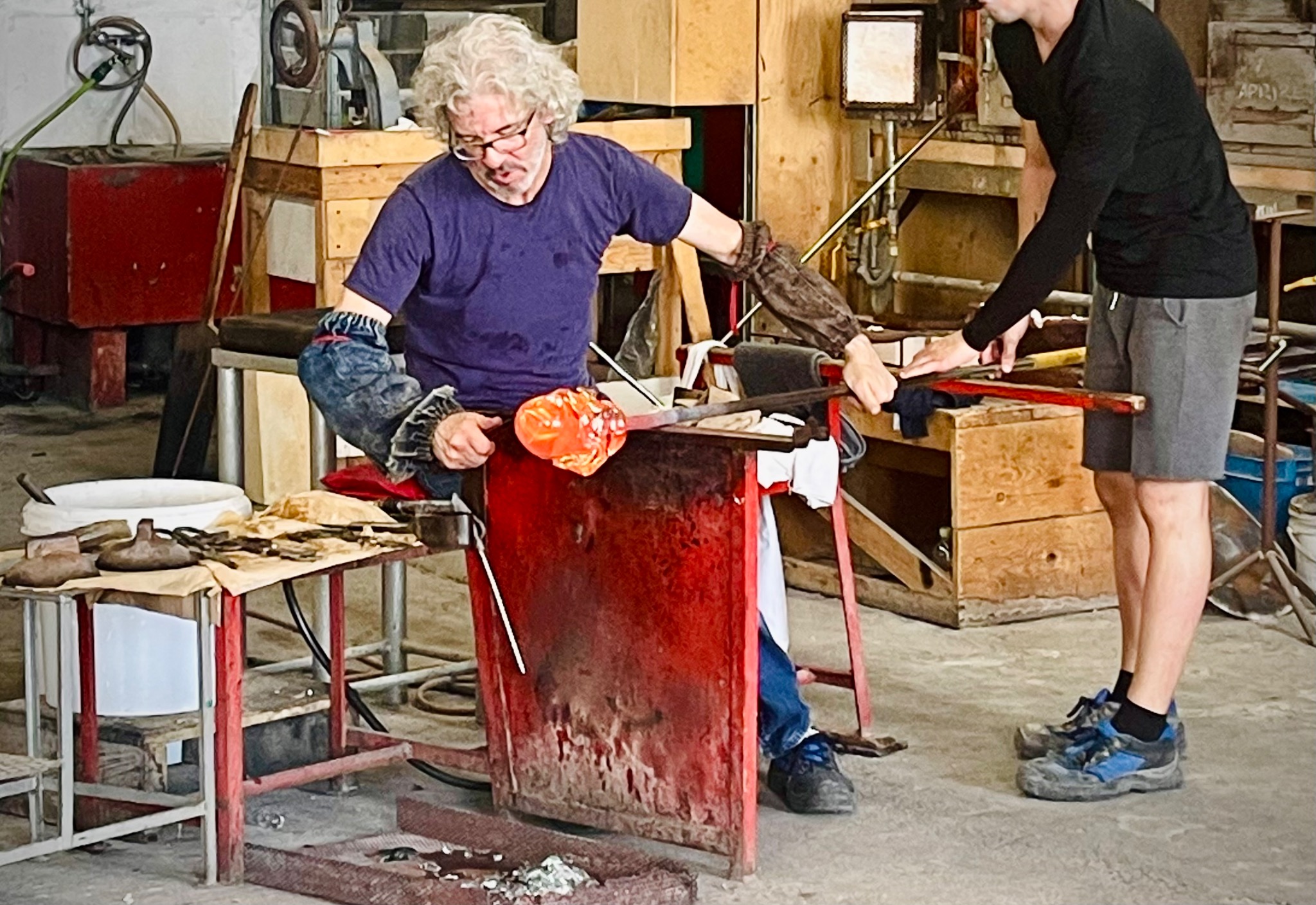 A Maestro vetraio shaping molten glass inside a working Murano furnace